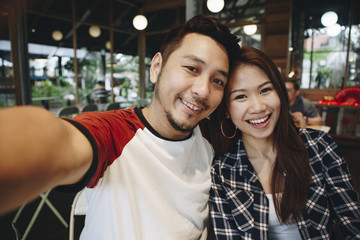 Happy couple taking selfie together