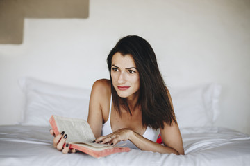 Woman reading a book in bed