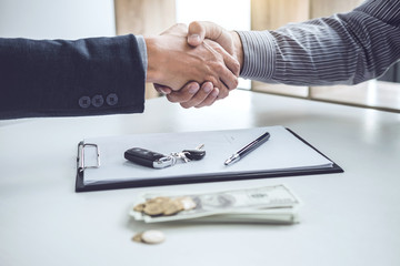Handshake of cooperation customer and salesman after agreement, successful car loan contract buying or selling new vehicle