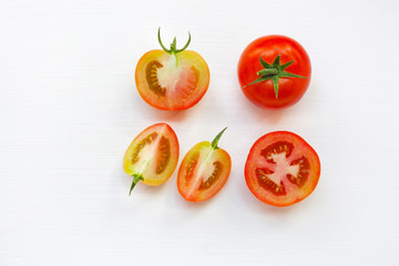 Fresh tomatoes on white wooden background.
