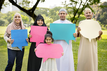 Muslim family holding up speech bubbles