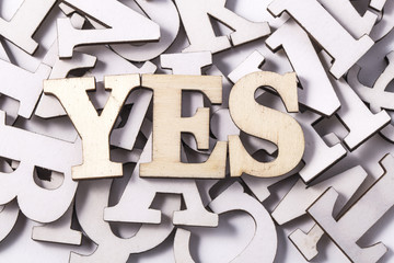 Alphabet letters on wooden scrabble pieces, isolated on white.