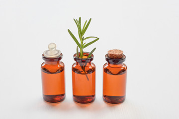  Glass bottle of essential oil  with rosemary.