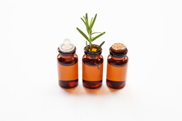  Glass bottle of essential oil  with rosemary.