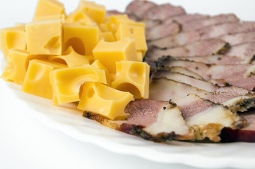 mountain with cheese, diced with sausage and bacon on a white plate