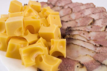 Cubes of hard cheese with homemade sausage and bacon