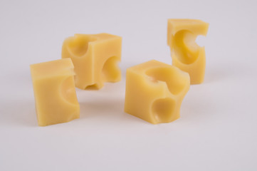 cheese diced on a light background