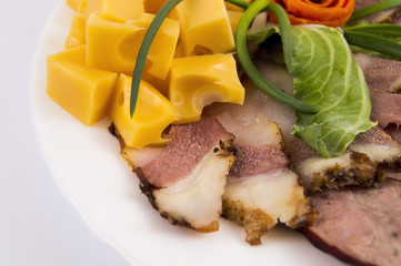 decoration of meat cuts from sausage, bacon with hard cheese