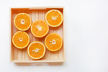 Fresh orange citrus fruit in wooden box.