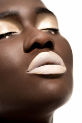 close-up portrait of beautiful sensual young african american woman with closed eyes and white makeup isolated on white