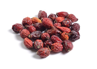 Dried medicinal herbs raw materials isolated on white. Dogrose or Rosa canina hips .