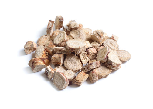 Dried medicinal herbs raw materials isolated on white. Root of Acorus calamus