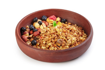 Bowl of homemade granola with fruit pieces isolated on white
