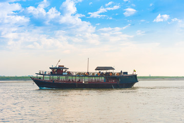 MANDALAY, MYANMAR - DECEMBER 1, 2016: Tourist boat on the river Irrawaddy, Burma. Copy space for text.