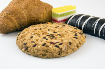 marmalade, croissant, shortbread and chocolate chip cookies on a light background