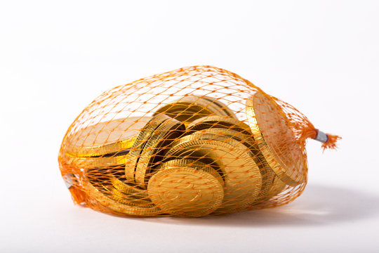 chocolate coin gold in mesh bags on white background.