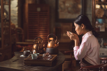 Young asian girl drinking tea