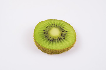 Slice of green kiwi on a light background