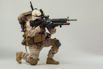 Soldier in camouflage holding rifle