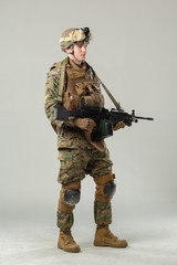 Soldier in camouflage holding rifle