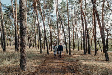 Fototapeta premium Love story. Couple in love and fun running in park. Happy end. Screensaver for the film. Traveling, holidays, vacation and friendship concept. Loving couple in countryside.