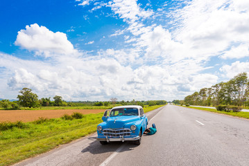 VINALES, CUBA - MAY 13, 2017: American retro car on the road. Copy space for text.
