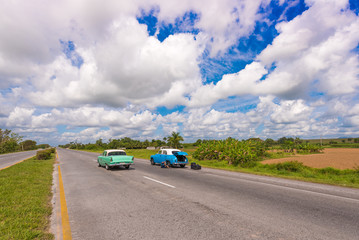 VINALES, CUBA - MAY 13, 2017: American retro cars on the road. Copy space for text.
