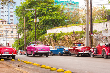 CUBA, HAVANA - MAY 5, 2017: American multicolored retro cars on city street. Copy space for text.
