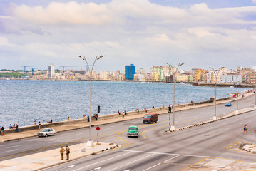 CUBA, HAVANA - MAY 5, 2017: Cars drive along the Malecon waterfront. Copy space for text.