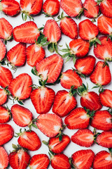 summer background with fresh juicy sliced strawberries on white