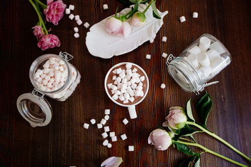 Cocoa with marshmallow and flowers.