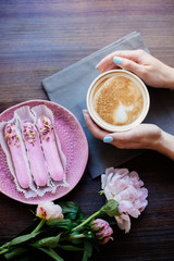 Cappuccino, eclairs and flowers.