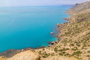Fototapeta na wymiar Sea and rocks landscape at Cape Meganom, the east coast of the peninsula of Crimea. Colorful background, travelling concept.