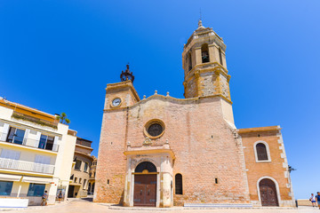 Fototapeta premium SITGES, CATALUNYA, SPAIN - JUNE 20, 2017: View of the church of of Sant Bartomeu and Santa Tecla. Copy space for text.