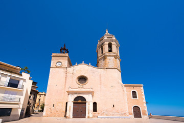 Fototapeta na wymiar SITGES, CATALUNYA, SPAIN - JUNE 20, 2017: View of the church of of Sant Bartomeu and Santa Tecla. Copy space for text.