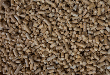 Wooden pet bedding background. Wood pellets texture.