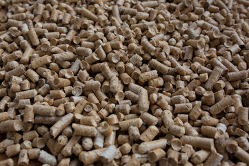 Wooden pet bedding background. Wood pellets texture.
