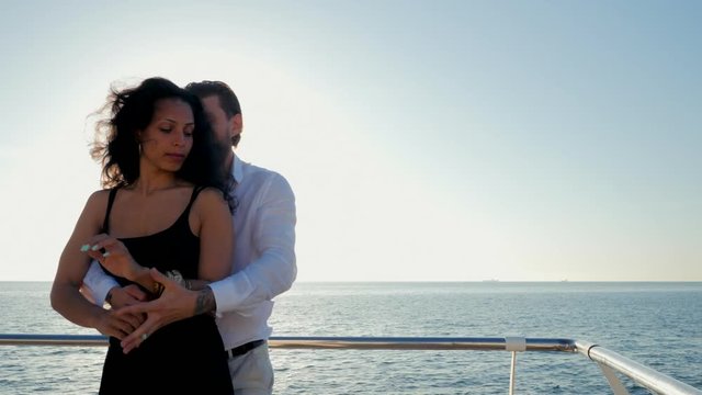 Energetic spanish couple against the background of the sunrise and ocean demonstrates elements of sensual Latin dance: bachata, rumba or kizomba. Slow motion.