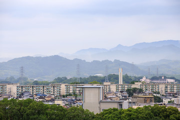 Misty mountains behind a Japanese apartment complex on the edge of town