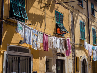 Fototapeta na wymiar Laundry drying in front of apartment, Cinque Terre Italy