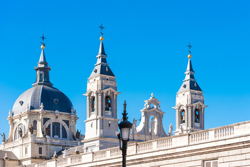 Fototapeta na wymiar MADRID, SPAIN - SEPTEMBER 26, 2017: Cathedral Almudena on the blue sky backgroun. Copy space for text.