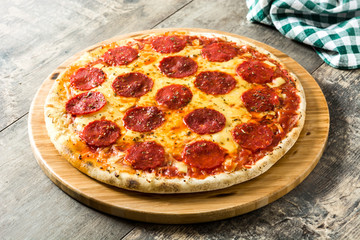 Hot italian pepperoni pizza on wooden table