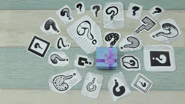 Blue gift box and question marks