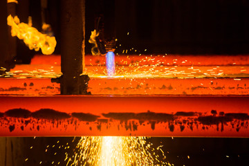 Cutting metal with oxygen. High temperature. Hot metal close up. Steel production