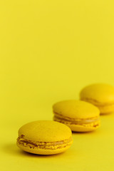 Delicious macaron with yellow background