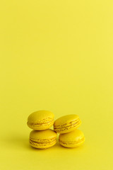 Delicious macaron with yellow background