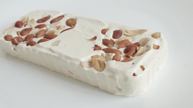 Nougat halva with almonds on white video