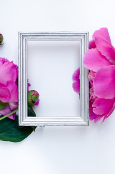Fototapeta Pink peony flower in frame Flat lay Nature concept on white background with copy space for greeting message creative layout. Mother's Day and spring background concept.