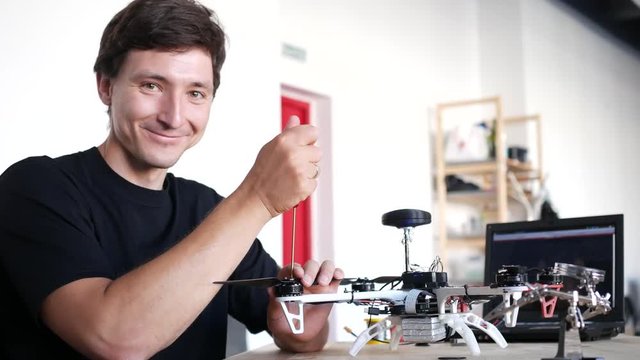 Portrait ofa technician fixing drone.