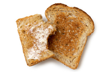 Half eaten buttered slice of whole wheat toast and whole dry slice of toast isolated on white from...